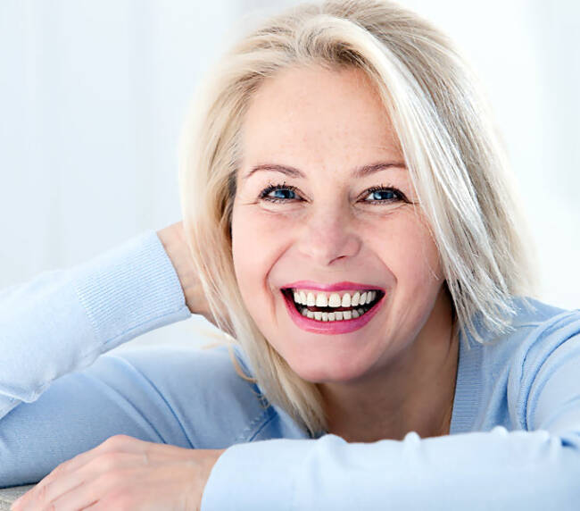 Smiling woman- dental crowns